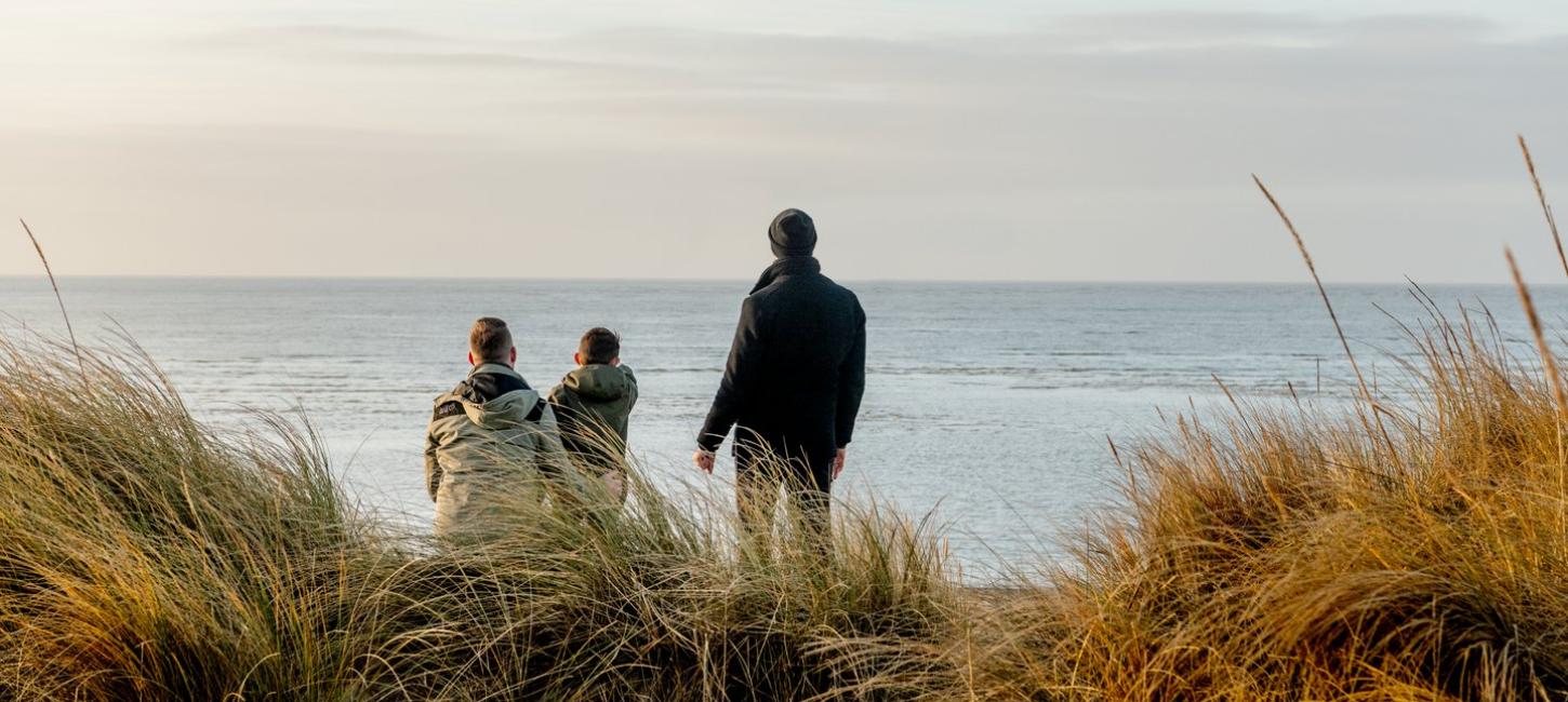 Family looking to the sea at Blåvand beach, West Jutland