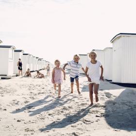 Children running on Løkken Beach, North Jutland